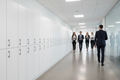 Modern corporate office corridor with row of white laminate single-tier lockers