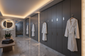 Luxury spa locker room with charcoal phenolic 4-tier lockers and terrycloth robes