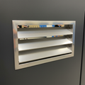 Aluminum ventilation louver installed in dark phenolic locker door showing 45-degree blade angle